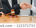 Law and justice concept, businessman shaking hands with lawyer to seal agreement with lawyer, partner or lawyer discussing contract agreement The concept of holding hands. 122371733