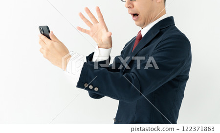 Businessman looking at a smartphone Businessman looking at a smartphone 122371863