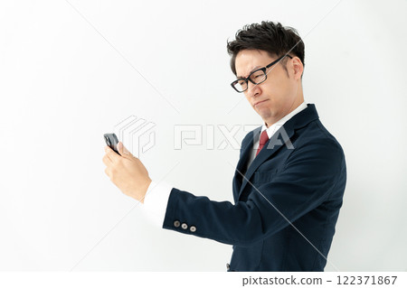 Businessman looking at a smartphone 122371867