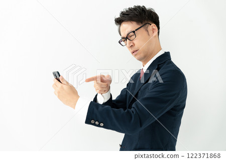 Businessman looking at a smartphone 122371868