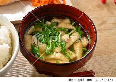 A Japanese meal image with one plate of side dishes such as teriyaki chicken and stir-fried spinach. Rice and miso soup are also included. 122372164