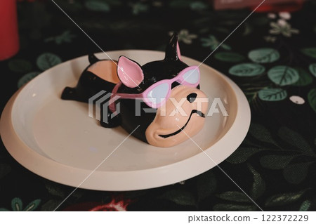 This Playful Cow Figurine with Sunglasses is placed charmingly on a decorative plate 122372229