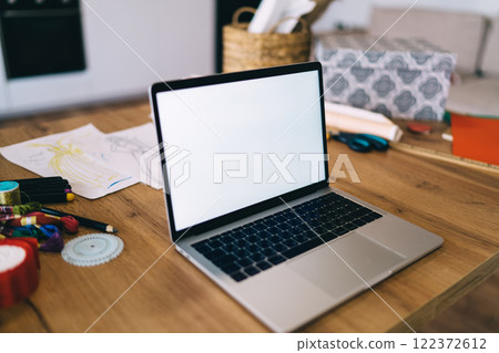 Laptop with blank screen on table Laptop with blank screen on table 122372612