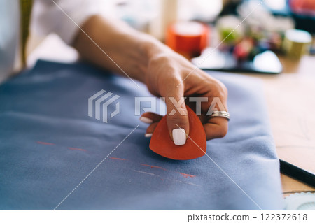 Seamstress marking on cloth with chalk Seamstress marking on cloth with chalk 122372618