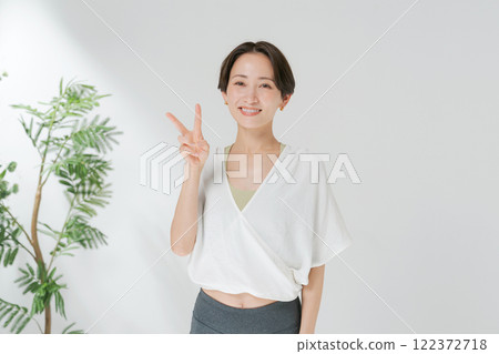 A woman posing in yoga wear 122372718