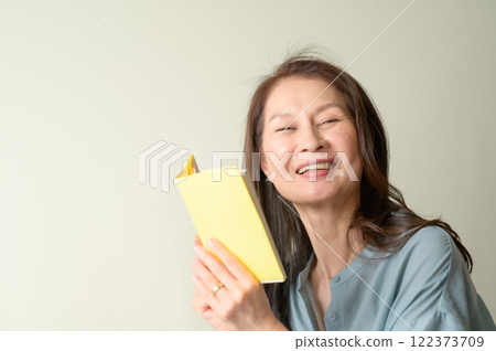 Senior woman enjoying reading Senior woman enjoying reading 122373709