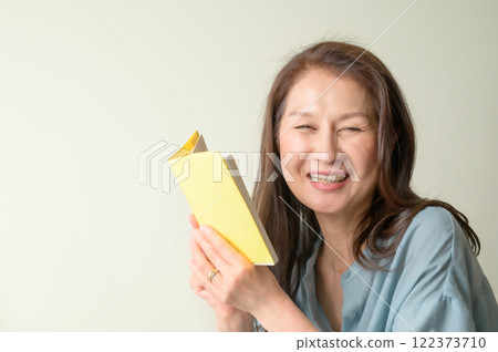 Senior woman enjoying reading Senior woman enjoying reading 122373710