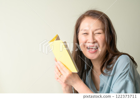 Senior woman enjoying reading Senior woman enjoying reading 122373711