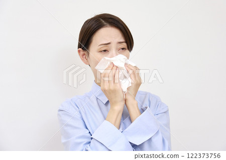 Woman blowing her nose on white background 122373756