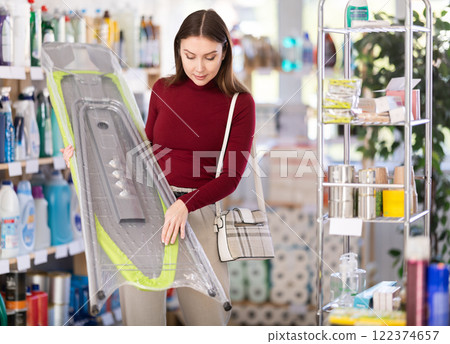 Woman choosing a folding board Woman choosing a folding board 122374657
