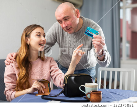 Husband giving plastic card to his wife 122375081