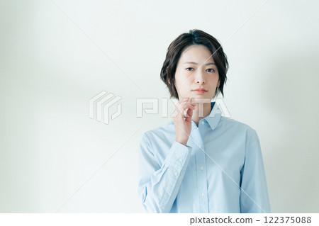 A woman who is concerned about her jawline A woman who is concerned about her jawline 122375088