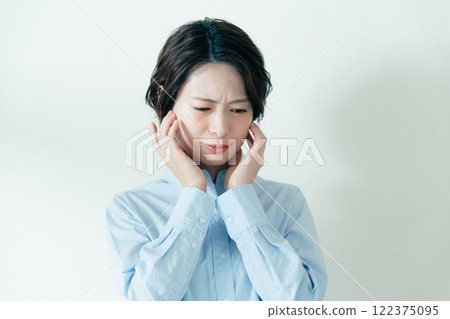 A woman who is concerned about her jawline A woman who is concerned about her jawline 122375095