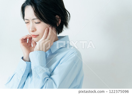 A woman who is concerned about her jawline A woman who is concerned about her jawline 122375096