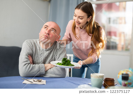 Man dissatisfied by dinner made by his wife Man dissatisfied by dinner made by his wife 122375127