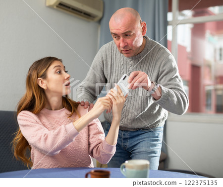 Man takes a woman mobile phone 122375135