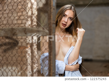 Sensual woman undressing in deserted building 122375243