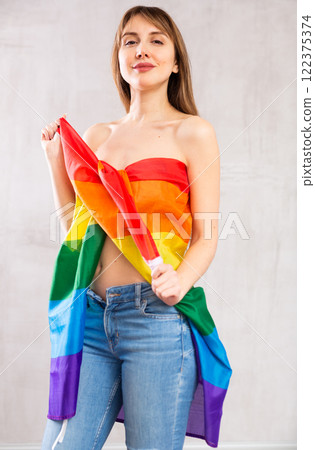 Sexy young woman standing with transgender flag Sexy young woman standing with transgender flag 122375374