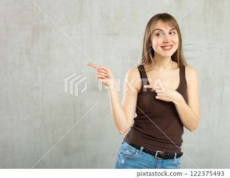 Smiling young woman gesturing in studio Smiling young woman gesturing in studio 122375493