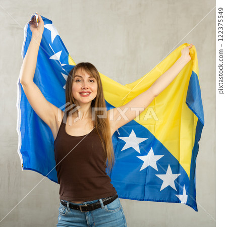 Young pretty woman proudly displaying flag of bosnia and herzegovina Young pretty woman proudly displaying flag of bosnia and herzegovina 122375549
