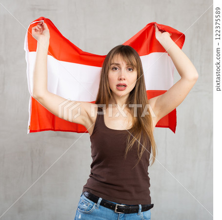 Sorrowful woman posing in studio with flag of Austria 122375589