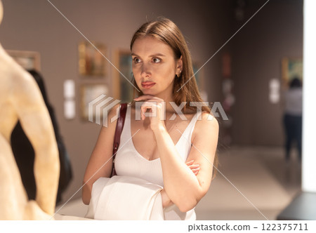 Girl view sculpture in museum hall 122375711