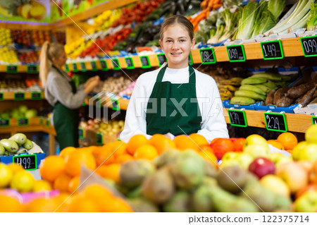 Portrait of smiling girl who works part-time in a store as trainee seller 122375714