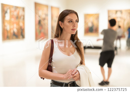 Girl view pictures and icons in museum hall 122375725