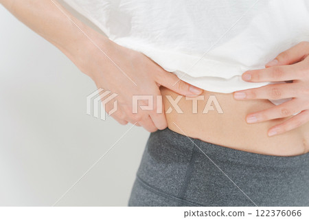 A woman holding a stomach luxury A woman holding a stomach luxury 122376066