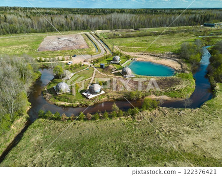An Aerial View of EcoFriendly and Sustainable Structures Situated Near a Beautiful Waterbody An Aerial View of EcoFriendly and Sustainable Structures Situated Near a Beautiful Waterbody 122376421