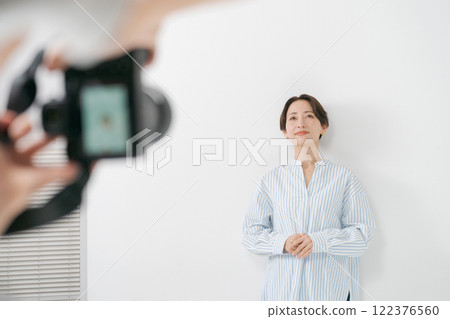 Female model being photographed in a studio 122376560