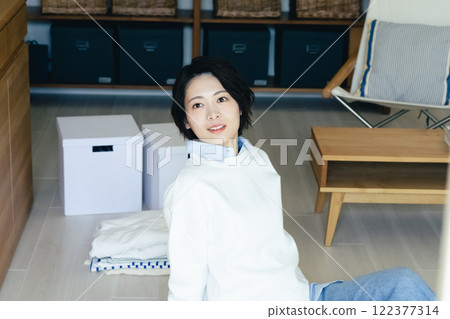 Woman looking outside from the living room Woman looking outside from the living room 122377314