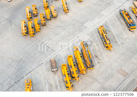 Yellow construction digger are parked at parking lots, top view. 122377506