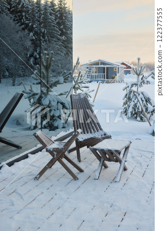 A Cozy Winter Retreat Nestled in a Snowy Landscape Surrounded by Beautiful Wooden Furniture 122377555
