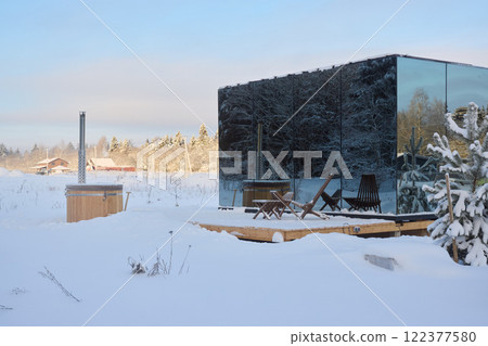 A Stunning Modern Glass Cabin Nestled in a Beautiful Winter Landscape Surrounded by Snow 122377580