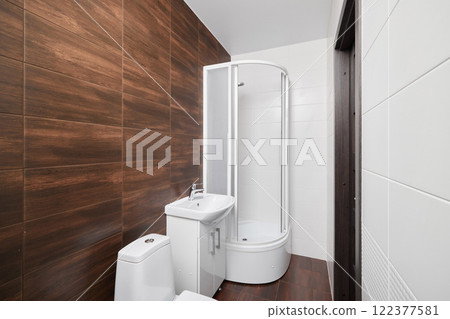 Explore modern bathroom design featuring a stylish shower and a sleek toilet space 122377581