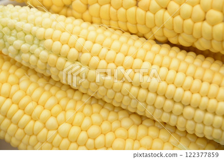 kidneys of raw corn lie on a dark wooden background kidneys of raw corn lie on a dark wooden background 122377859