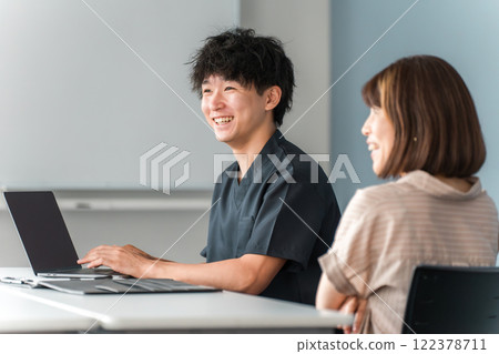 Male and female patients with doctors, nurses and counselors undergoing medical examinations, treatment, counselling and consultations at a hospital 122378711