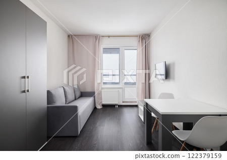 A Modern Minimalist Living Space with Natural Light, Functional Design, and elegance 122379159