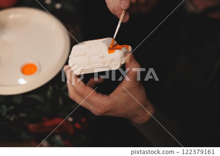 Crafting a colorful miniature vehicle with vibrant paint and artistic skills is joyful 122379161