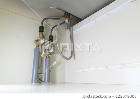 Leaking faucet (actual view under the sink) 122379305