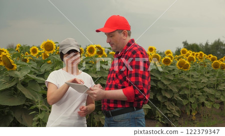 Agriculture, teamwork, business partner farmer agriculture, handshake sign of deal, harvest, fresh soil grow crops, woman farmer showing harvest business partner, handshake sign deal, two farmers 122379347