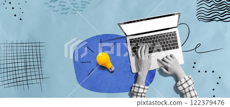 Person using a laptop computer and light bulbs Person using a laptop computer and light bulbs 122379476