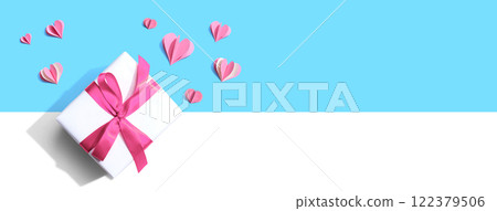 Gift box with pink paper hearts 122379506