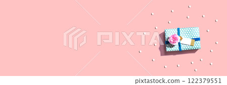 Gift box with carnation flower overhead view 122379551