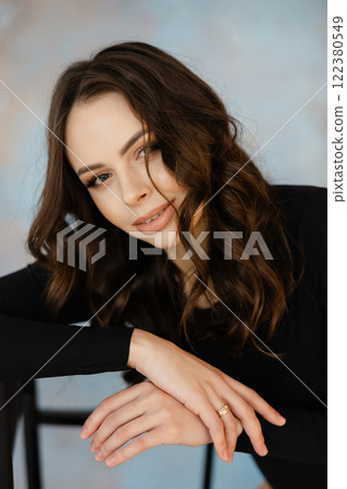 Young Woman Relaxing with Confident Expression Young Woman Relaxing with Confident Expression 122380549