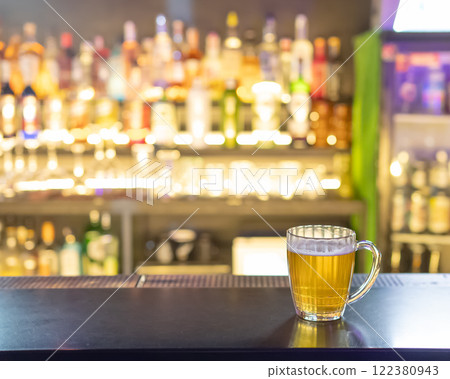 A mug of beer on the bar counter in a pub. 122380943