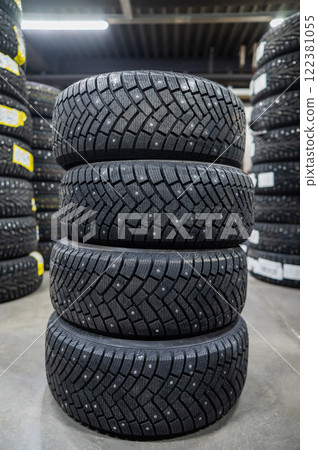 New car studded tires in the store. Vertical photo.  122381055