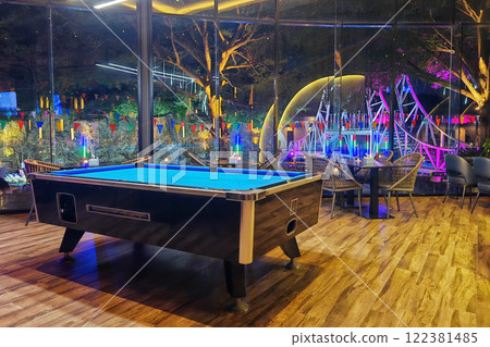 pool table inside restaurant with outdoor light up view at night pool table inside restaurant with outdoor light up view at night 122381485