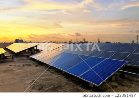 Solar panels on roof of office building against sunset sky Solar panels on roof of office building against sunset sky 122381487